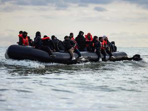 Migranten sitzen auf einem Schlauchboot und versuchen, den Ärmelkanal zu überqueren. (Symbolbild)